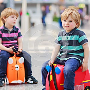 Two brother boys going on vacations trip at airport