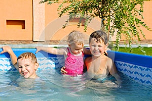 Two brothers and baby sister in the pool