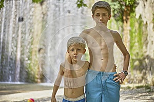 Two brothers boys standing embraced in summer holidays love family belonging together trust childhood