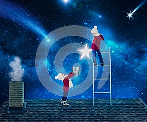 Two brothers in Christmas night standing on the roof of the house and collect the stars from the sky in a bucket.Merry Christmas .