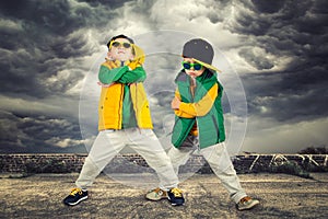 Two brothers dancing break dance.Hip-hop style.The cool kids.Children`s fashion.