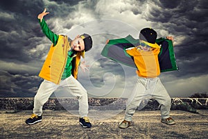 Two brothers dancing break dance.Hip-hop style.The cool kids.Children`s fashion.