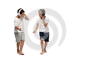 Two brothers listening music in headphones and dancing