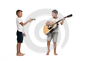 Two brothers looking at camera and dancing while listening music in headphones
