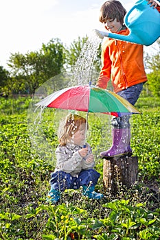 Two brothers play in rain