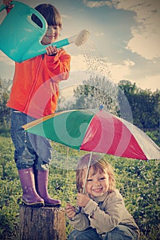 Two brothers play in rain