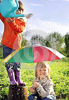 Two brothers play in rain