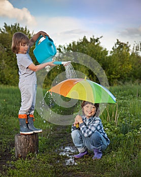 Two brothers play in rain