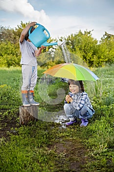 Two brothers play in rain