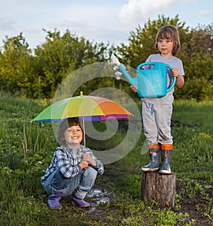 Two brothers play in rain outdoors