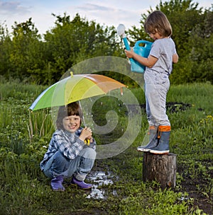 Two brothers play in rain outdoors