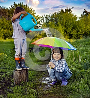 Two brothers play in rain outdoors