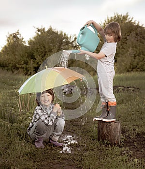 Two brothers play in rain outdoors retro edit