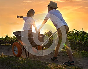 Two brothers play together in the field.Child pilot aviator dreams of traveling.