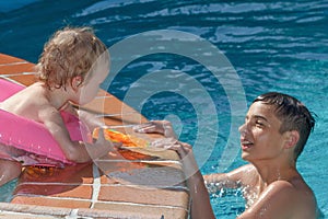 Two brothers playing in the pool