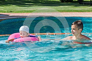 Two brothers playing in the pool