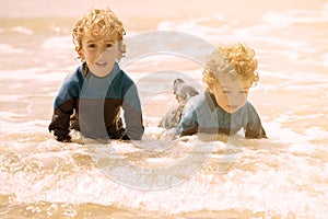 Two brothers playing on the shore