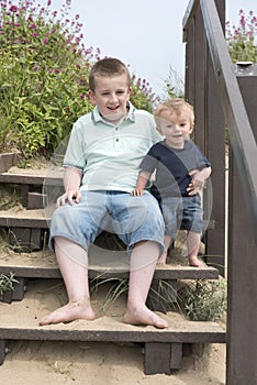 Two brothers playing together on the beach