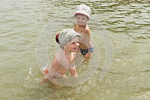 Two brothers playing in the water