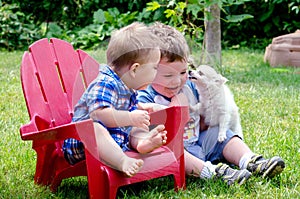 Two brothers and puppy kiss photo