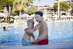 Two brothers are resting in the pool