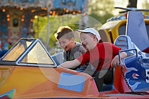 Two brothers ride on the carousel