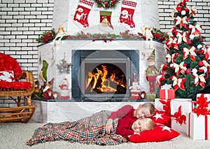 Merry Christmas and Happy Holidays!Two brothers sleep in the living room on the floor under the tree.In anticipation of gifts from