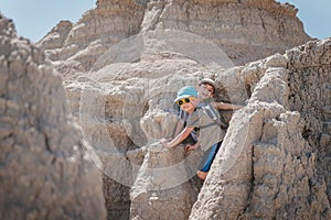 Two brothers smiling while exploring the rock formations of Badlands National Park