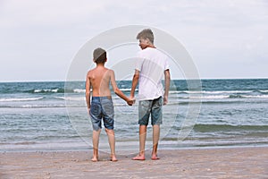 Two brothers of a teenager playing on the ocean, the friendship o