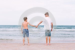 Two brothers of a teenager playing on the ocean, the friendship o