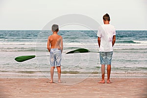 Two brothers of a teenager playing on the ocean, the friendship o