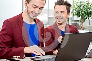 Two brothers twins working at the office