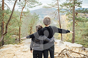 Two brothers are walking on mountains in Ukraine