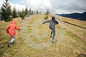 Two brothers are walking on mountains in Ukraine