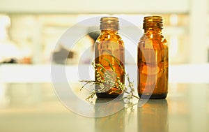 Two brown bottle with flower herb