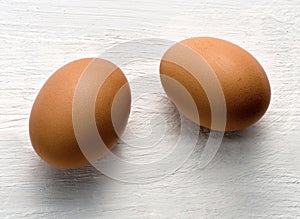 Two brown chicken eggs, healthy source of proteins