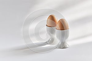 Two brown eggs in egg cups