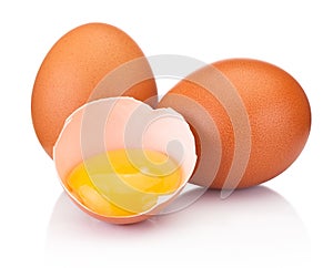 Two brown eggs and one is broken isolated white on white background