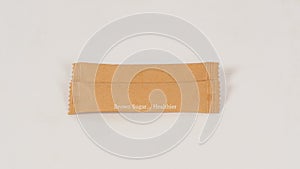 Two Brown sugar sachets on white background