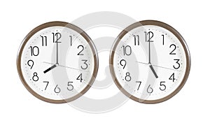 Two brown wall clock isolated on white background. Wall clock at eight and five o`clock isolated. Wall clock isolated