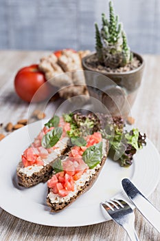 Two bruschettas, ginger, almonds, tomatoes and cactus