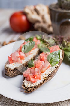 Two bruschettas, lettuce, ginger and tomatoes