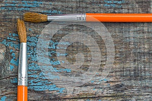 Two brushes on the background of the old wooden boards