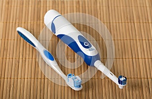 Two brushes for hygienic care of the oral cavity on beige mat