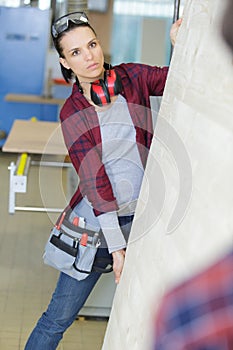 two builders carrying boards