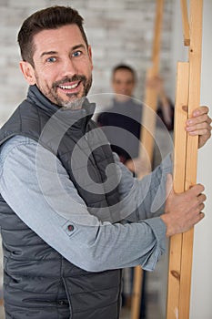 two builders installing wooden framework