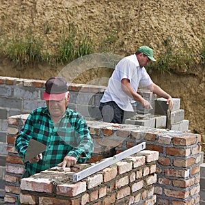 Two builders making walls photo