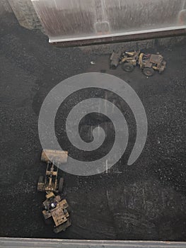 Two buldozer cleaning the ships hach