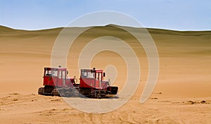 Two bulldozers working in desert