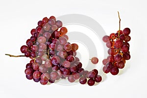 Two Bunches of fresh wine pink grapes falling isolated on a white background